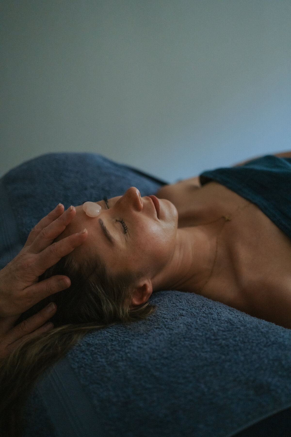 A guest receiving a calming holistic facial treatment at a previous retreat