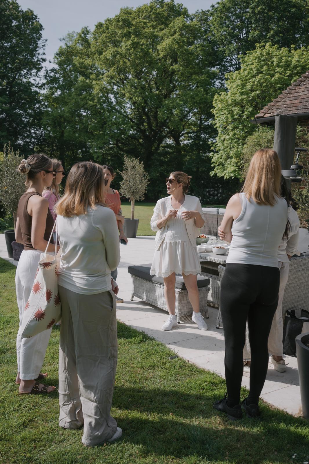 Guests arriving and gathering in the garden at a previous retreat